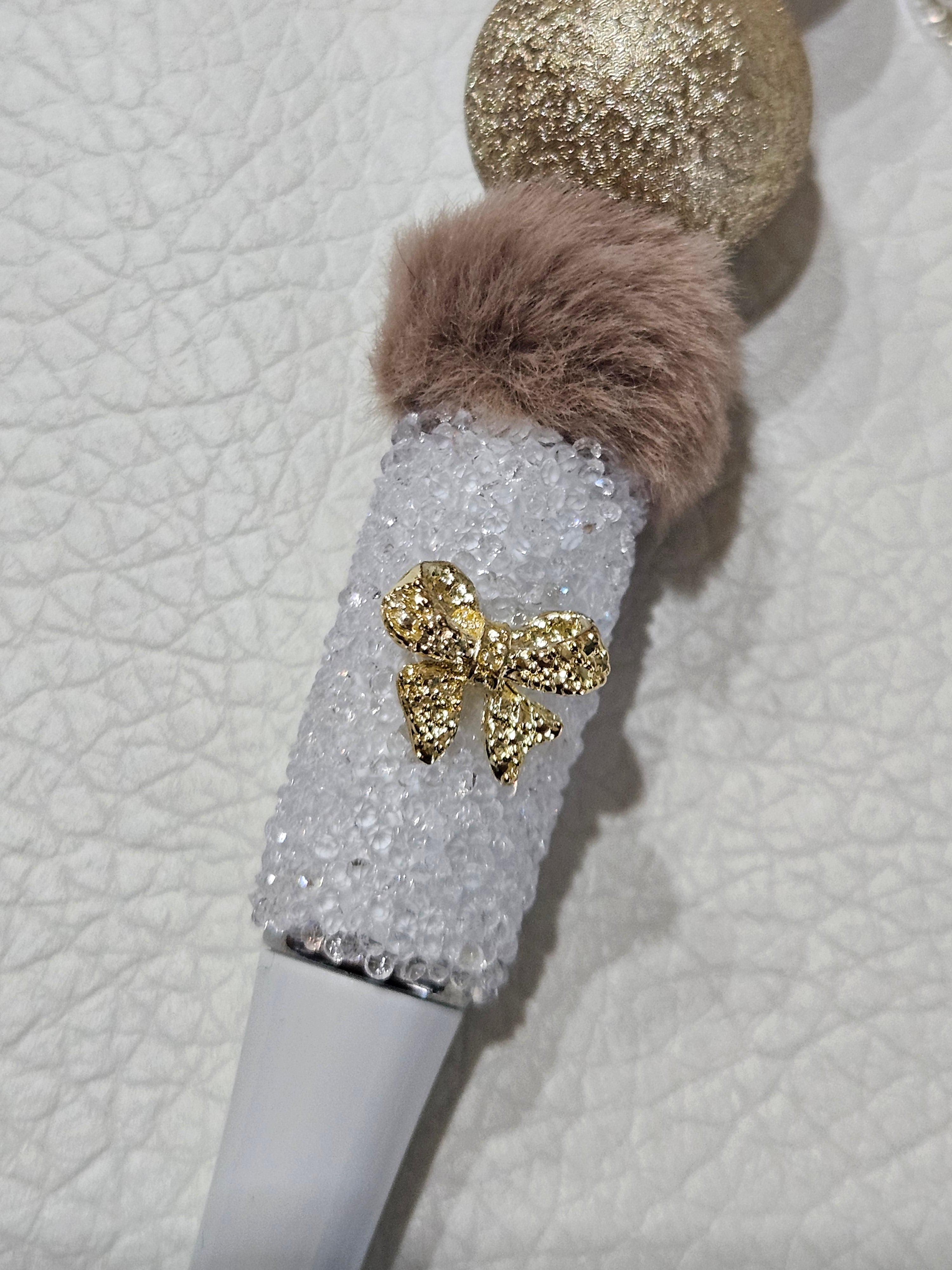 close up of gold bow on barrel, White sugar pen with JW charm
