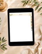 A tablet device displaying a notes app with a blank page and decorative header, placed on a light wood surface with a notebook, woven coaster, greenery, and draped fabric around it.