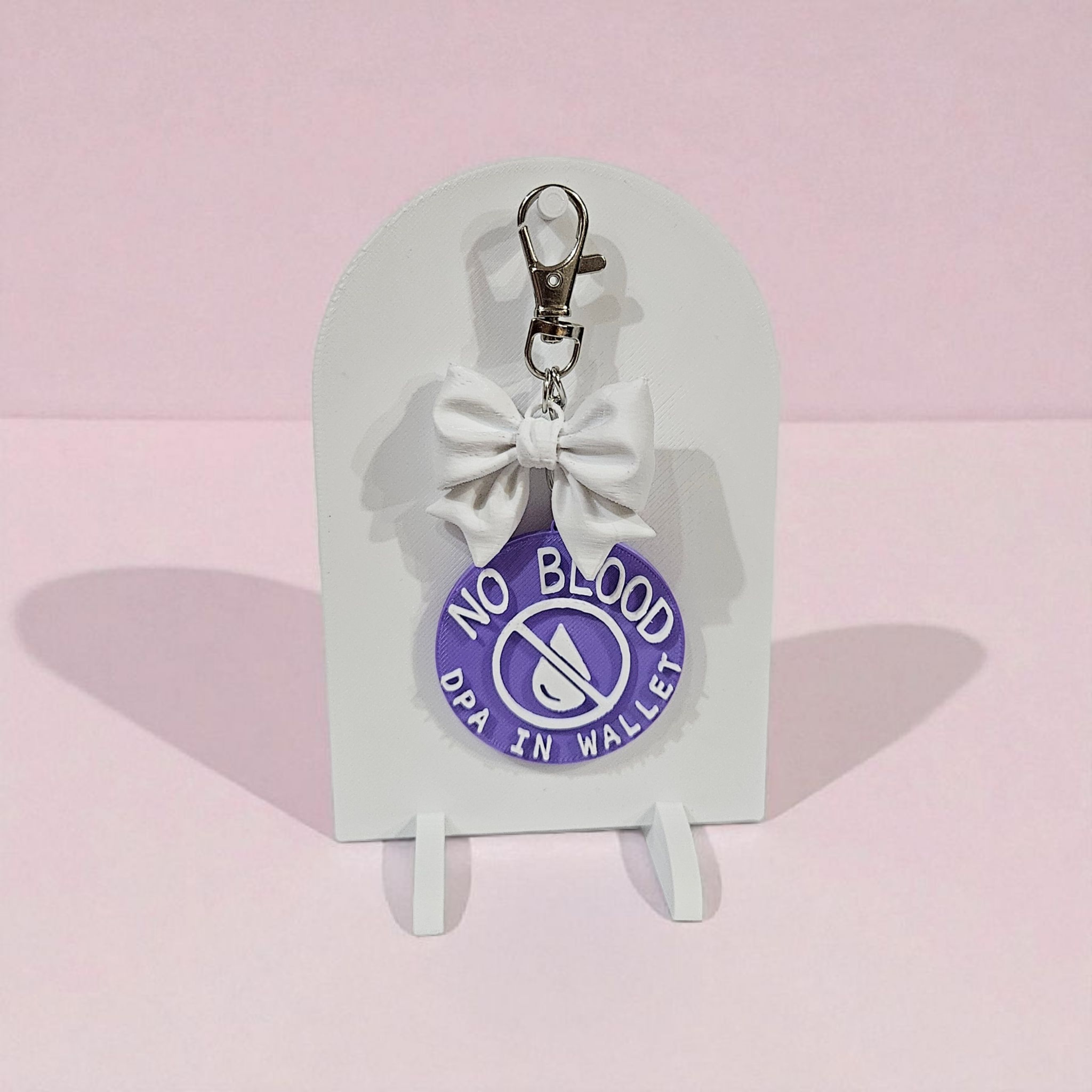 Handmade 3D printed “No Blood – DPA in Wallet” medical ID keychain in purple ombré, with optional 3D printed bow and lobster clasp, lightweight and durable for everyday use.