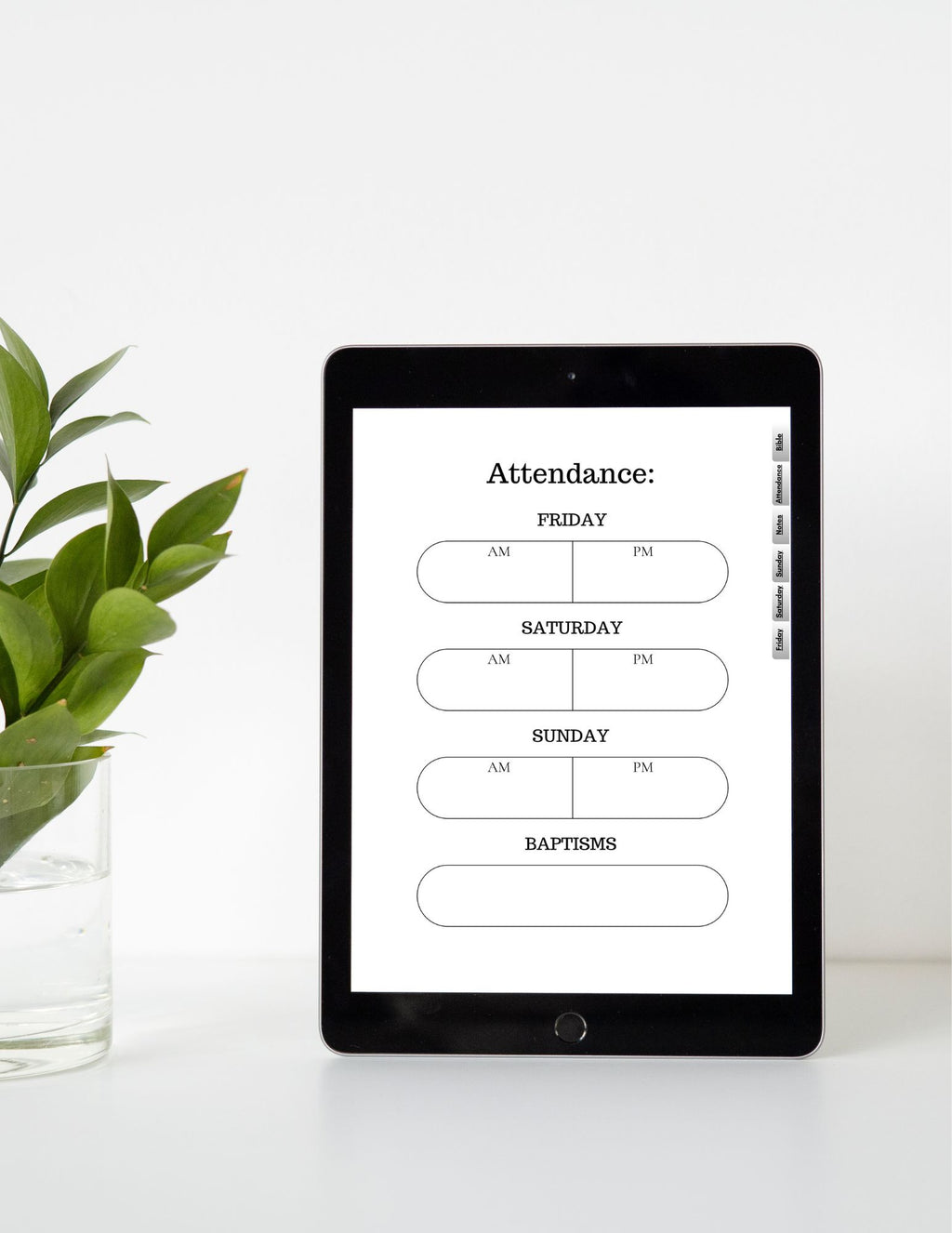 iPad displaying an attendance schedule on a white surface with a plant.
