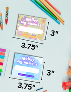 Name tags with dimensions and stationery items on a light blue background