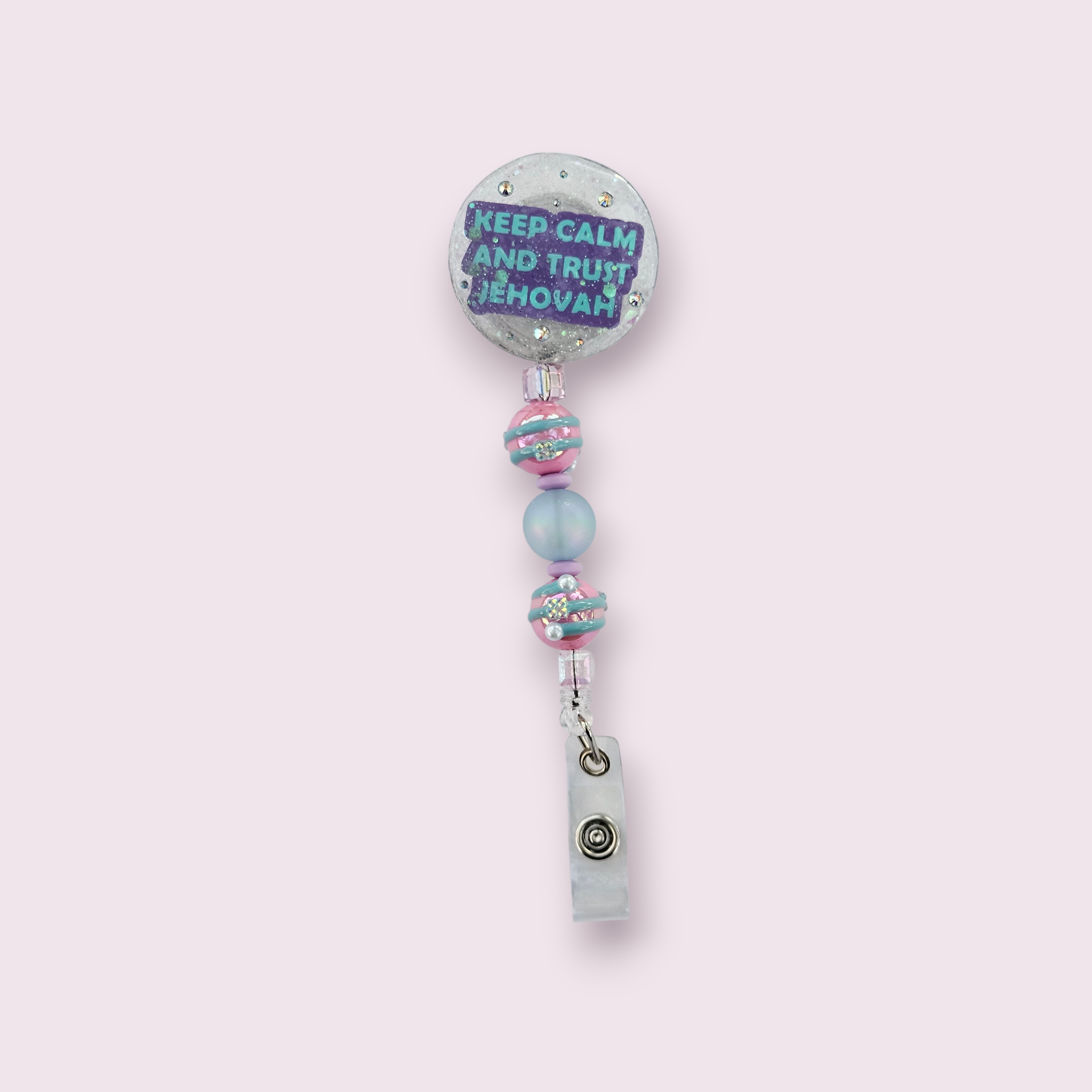 Hand-poured circle-shaped glitter resin badge reel with “Keep Calm and Trust Jehovah” message, iridescent glitter and pink & blue accent beads, for JW pioneers